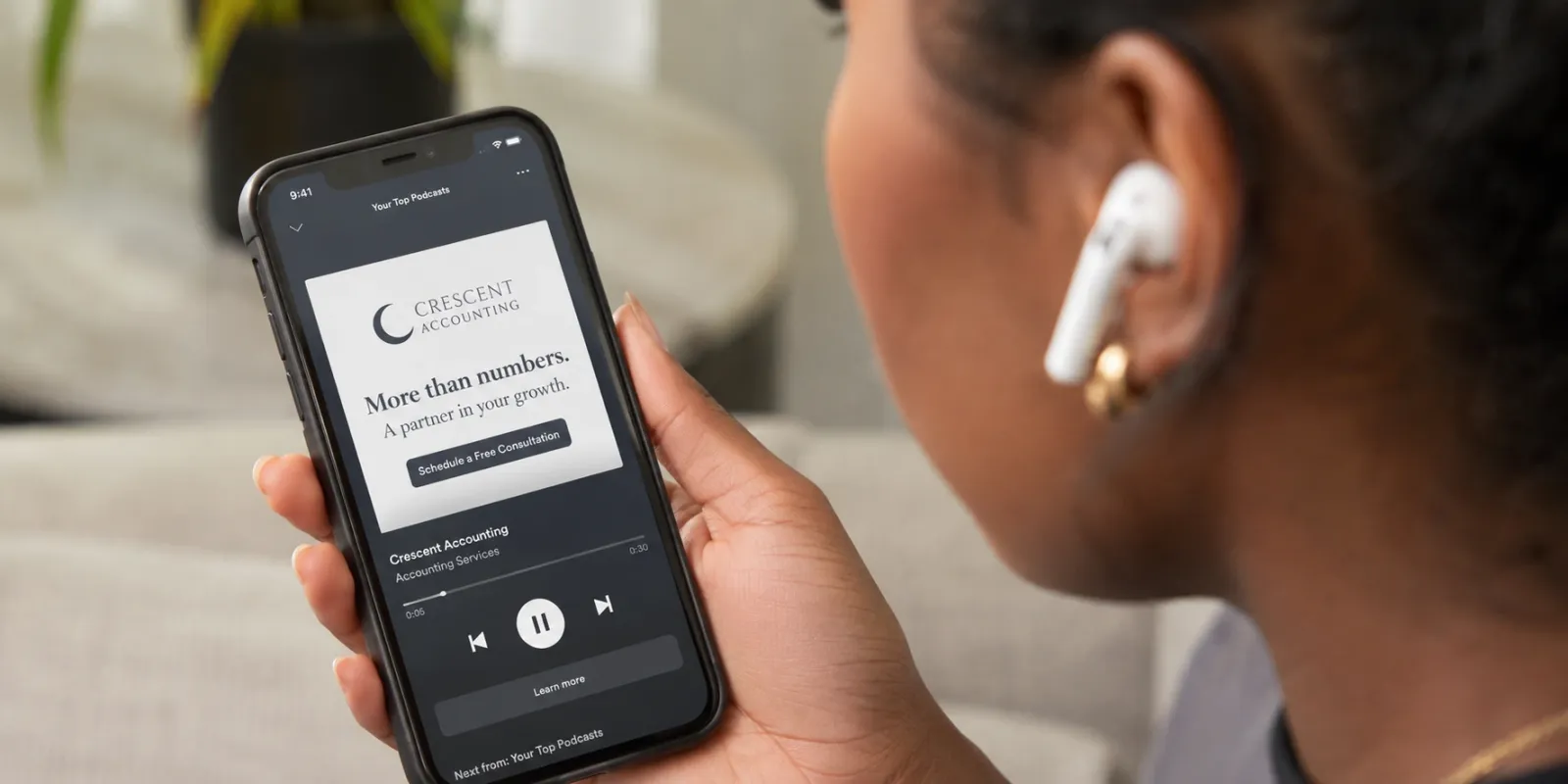 A person listening to an accounting advertisement on Spotify